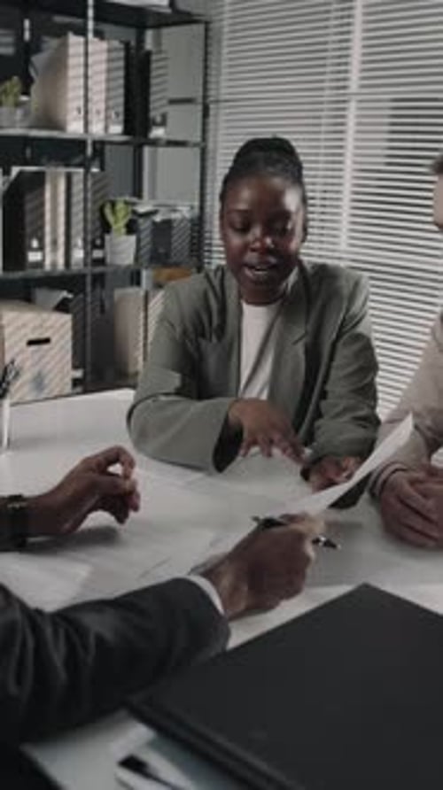 Woman Reviews Documents in Modern Office Meeting