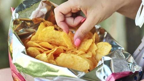 A Girl Eating Chips on a Summer Afternoon