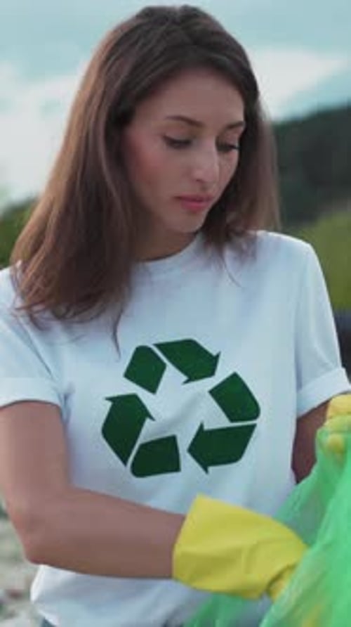 Young Woman Collects Recycling Outdoors