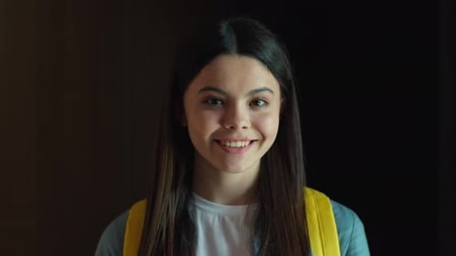 Smiling Teenager with Backpack Looking at Camera