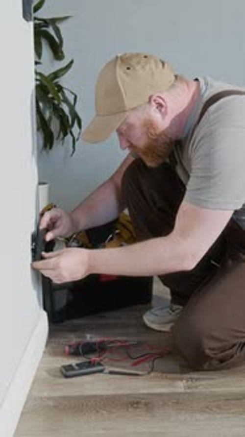 Man Fixing Electric Socket