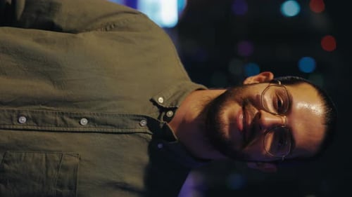 Portrait of Handsome Man Turning Head Standing on Night City Background Vertical Video