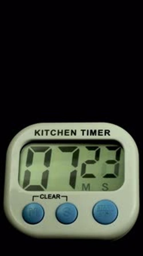 Time lapse of a kitchen clock timer countdown to zero.