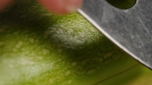 Zucchini Being Peeled with a Vegetable Peeler