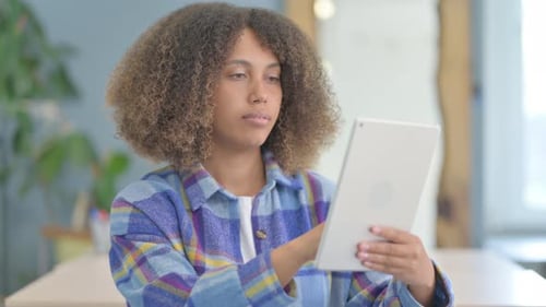 Portrait of Young African Woman using Tablet Computer