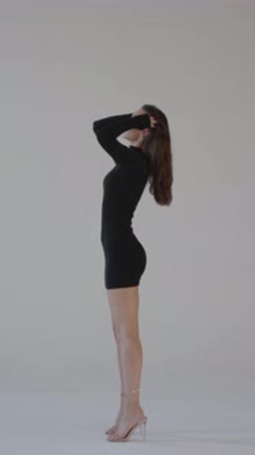 Woman Posing in Studio Wearing Little Black Dress