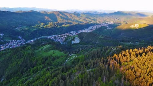 View From Rock to Town of Smolyan with Meadows for Cattle Walking and Houses Between Mountain Range