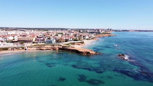 Aerial drone view of cityscape and coastline of Mil Palmeras beach and Pilar de la Horadada in Spain