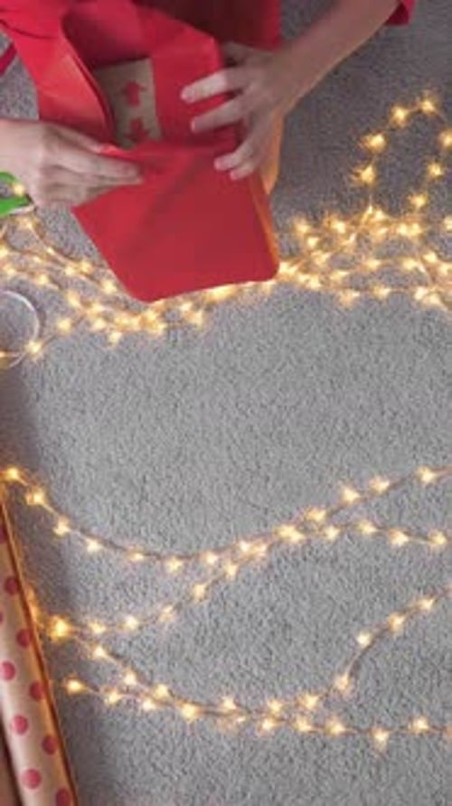 Imagine a Festive Area for Wrapping Christmas Gifts Adorned with Twinkling Lights Colorful