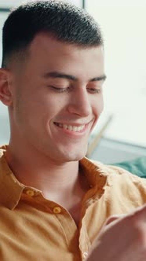 Home, man and laughing with smartphone for chat, online message and comment on funny reel in lounge