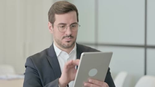 Man in Suit Using Tablet in Modern Office