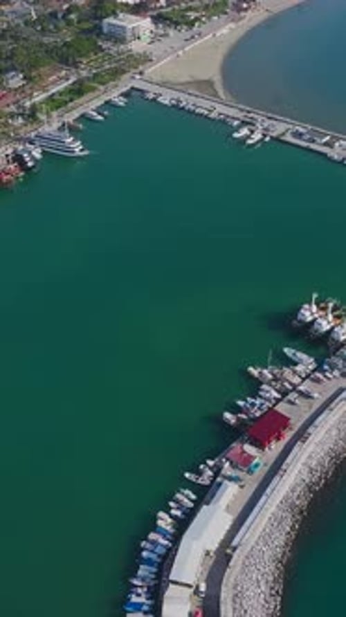 Vertical Video of a Mediterranean Port With Sailboats and Motor Yachts Captured From Above With a