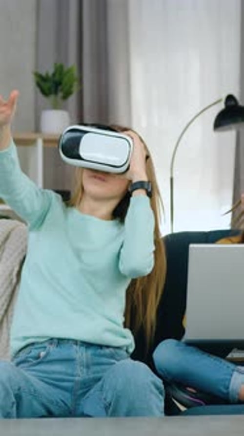 Woman using VR headset with a Child on Laptop