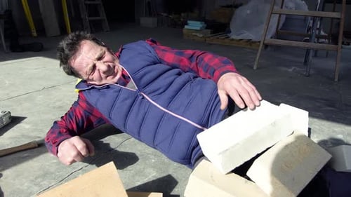 Man Lying on Ground with Bricks After Accident