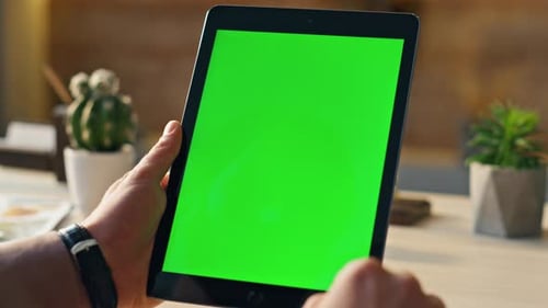 Businessman Hand Scrolling Greenscreen Tablet Searching Internet Information in Home Office. Close