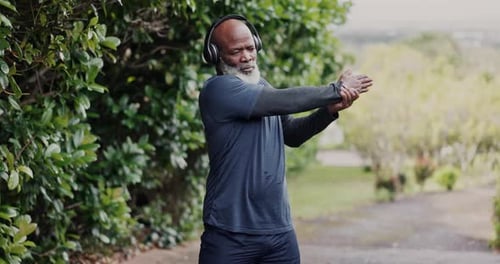 Black man, senior stretching with headphones and fitness in park, running and cardio with wellness