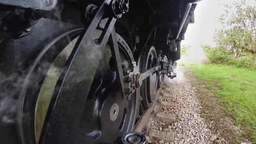 Historical Steam Engine Train Locomotive Driving on Railroad Tracks