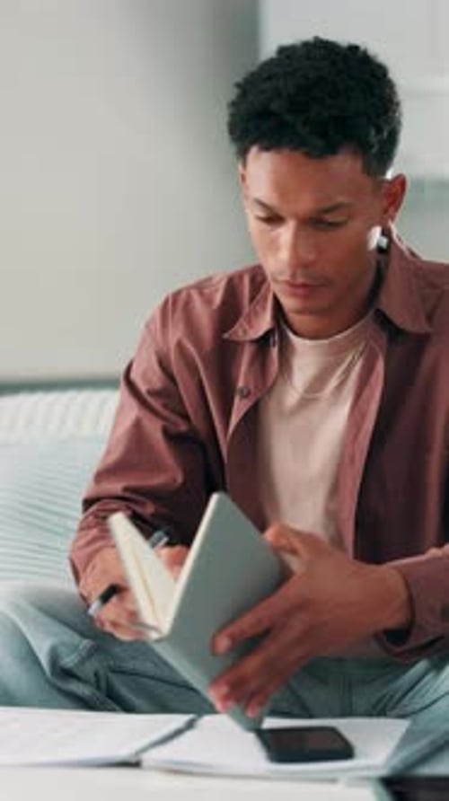 Man, student and studying with notebook in home for accounting course, finance or budget planning