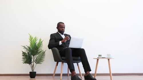 African Businessman Using Laptop for Video Conversation