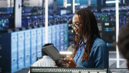Woman in Server Hub Using AI Visualization Insights on Tablet Device