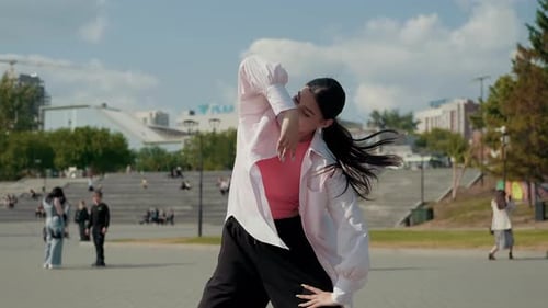 Girl Dancer Dancing Energetic Dance on the Street in Urban Atmosphere