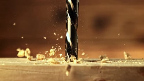Drill Bit Bores Into Wood Creating Shavings