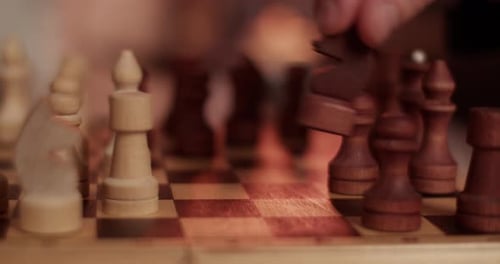 Hand Moves Chess Piece on Chessboard Game