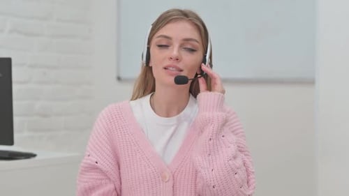 Woman with Headset in Call Center Doing Video Chat