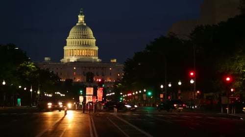 United States Capitol Building At Night From From Pennsylvania Avenue With Cars Driving, Washingt...