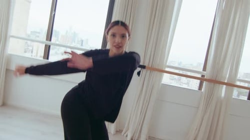 Auburn Haired Woman Dancing and Gymnastics in Urban Studio