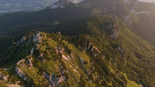 Aerial Drone Orbit Shot Around a Majestic Mountain Peak at Sunset