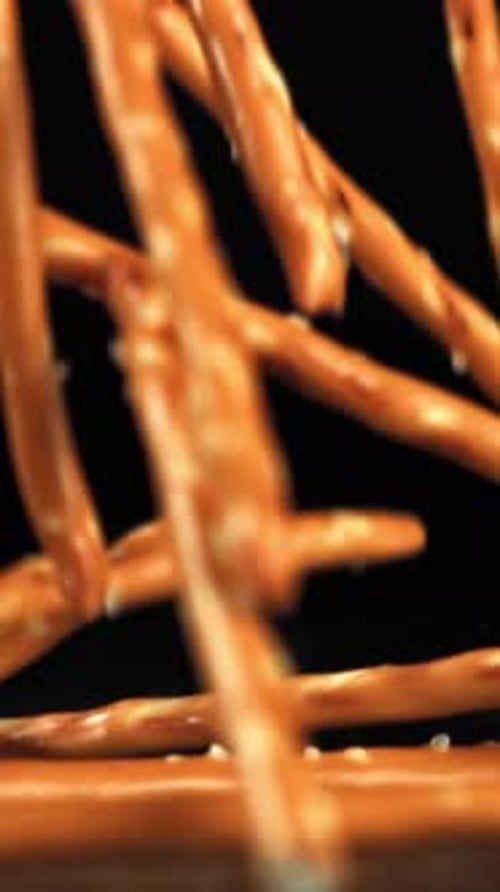 Salted Cracker Sticks Fall on the Table Filmed on a Highspeed Camera at 1000 Fps