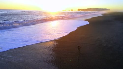 Aerial Drone View of Reynisfjara Black Sand Beach at Sunset in Iceland