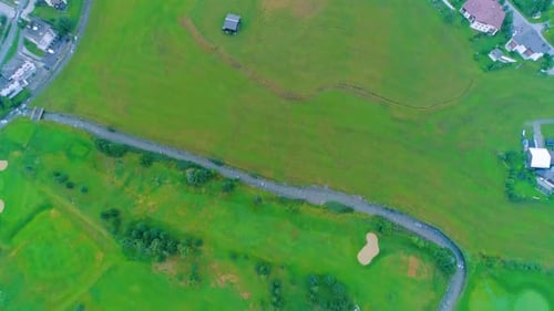 4K aerial shot flying above the clouds on sunrise at a village in the alps