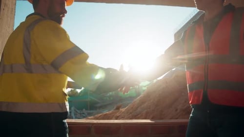 People, construction and meeting with handshake on site for building deal or partnership together