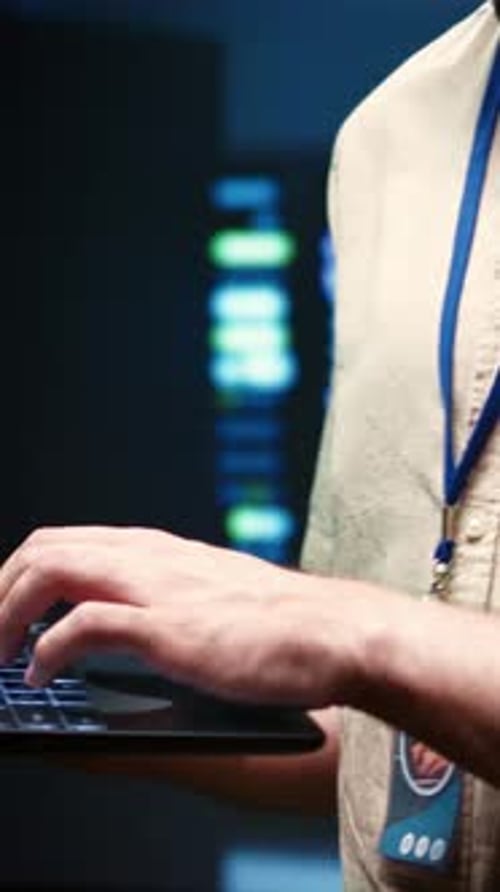 Person Typing on Laptop in Tech Office