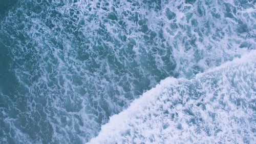 Aerial View of Ocean Waves Crashing