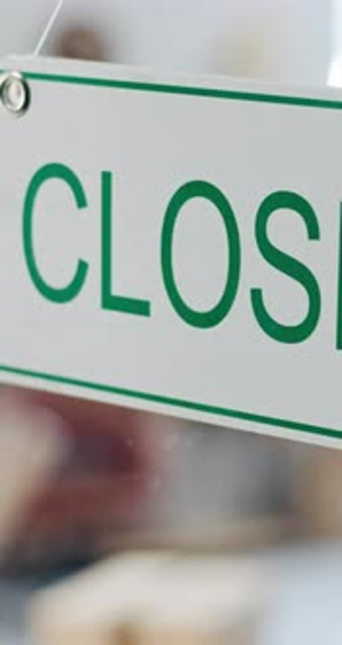 Closed, sign and window closeup for business store or operation hours for information