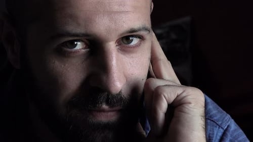 stressed and worried man absorbed by his thoughts stares at the camera