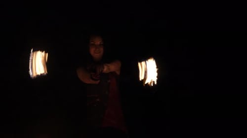 Woman Fire Dancing Performance at Night