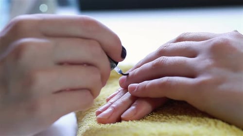 Closeup of a Woman Using a Cuticle Pusher