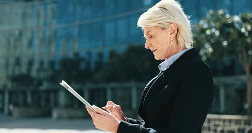 City, mature and a business woman with a tablet for email check, connection and communication