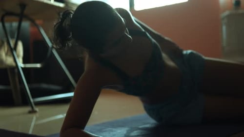 Beautiful Indian woman doing yoga exercises in the living room