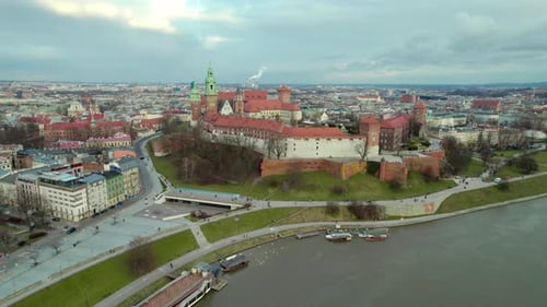 Side dolly shot over Vistula rives with Krakow Wawel Royal Castle, city center fortress with the old