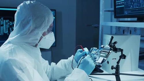 Microelectronics Engineer Works in a Modern Scientific Laboratory on Computing Systems and