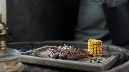 a restaurant guest is salting a steak