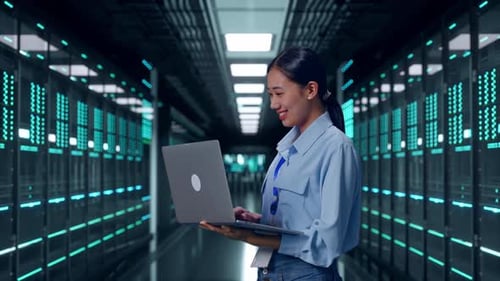 Asia Female Professional Worker Use Laptop In Data Center