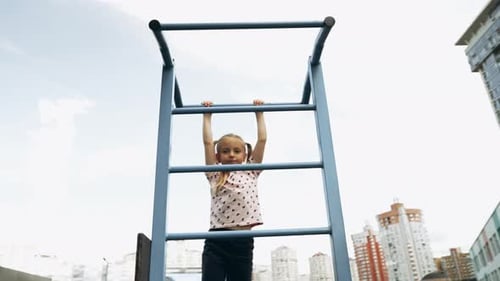 Child Climbs Playground Structure in Urban Park During Sunny Afternoon