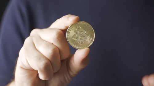 Bitcoin Held and Displayed in Hand