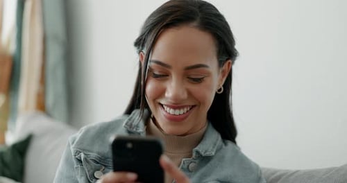 Smiling Woman Using Smartphone in Cozy Home Setting